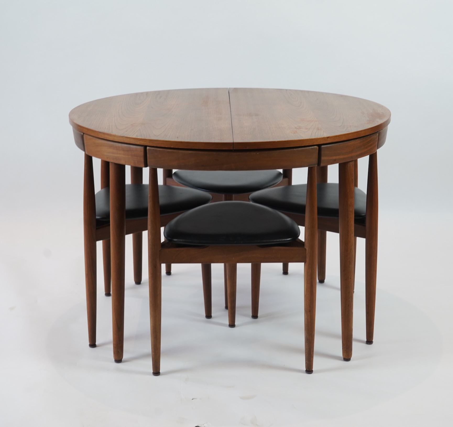 Hans Olsen (Danish, 1919–1992) for Frem Røjle: A Danish teak 'Roundette' extending dining table and four chairs